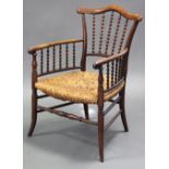 A Victorian rosewood small rush-seat armchair, with shaped top-rail & curved open arms with bobbin-t