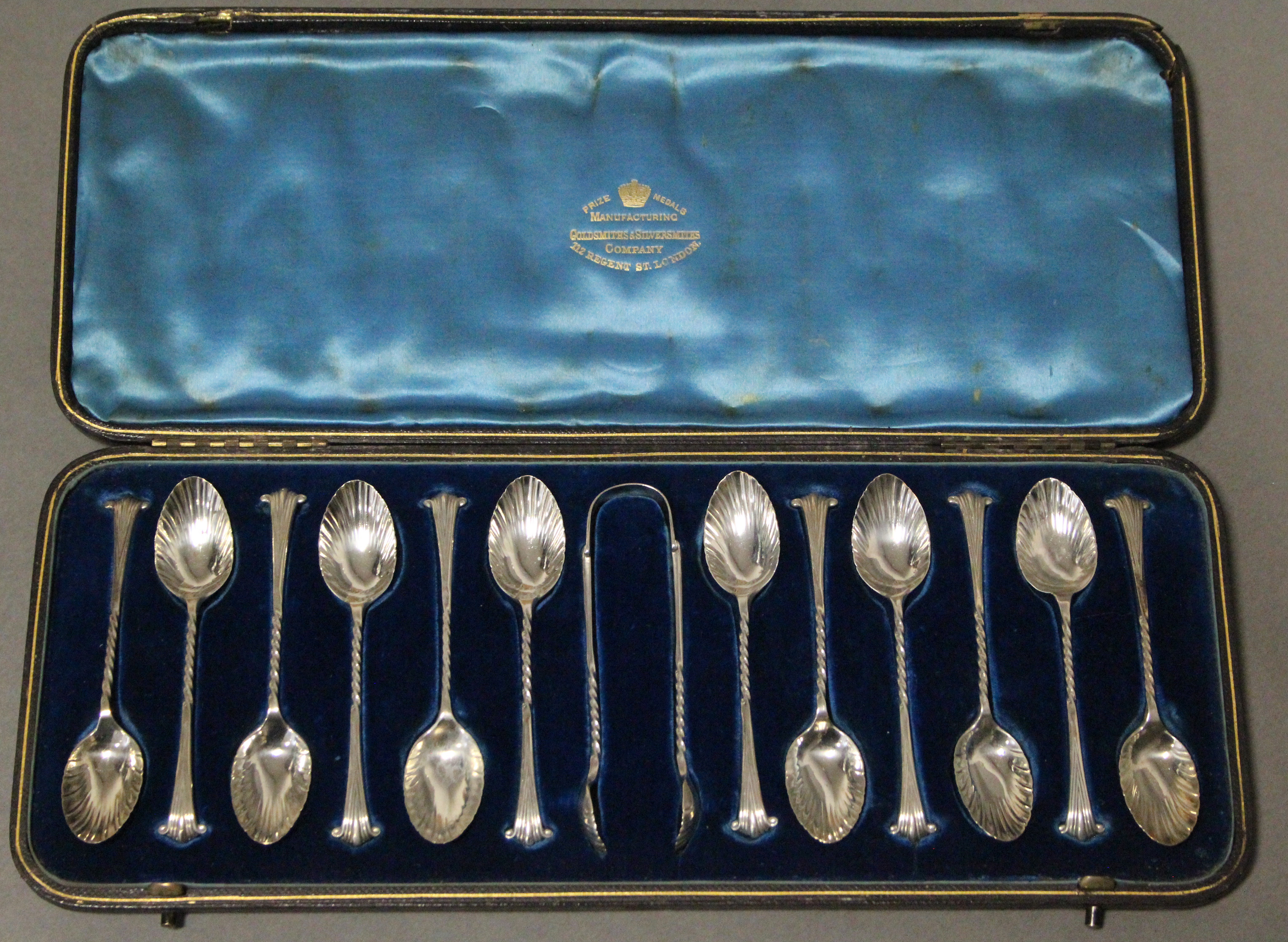 A set of twelve Victorian silver Onslow pattern teaspoons & matching sugar tongs with writhen