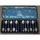 A set of twelve Victorian silver Onslow pattern teaspoons & matching sugar tongs with writhen