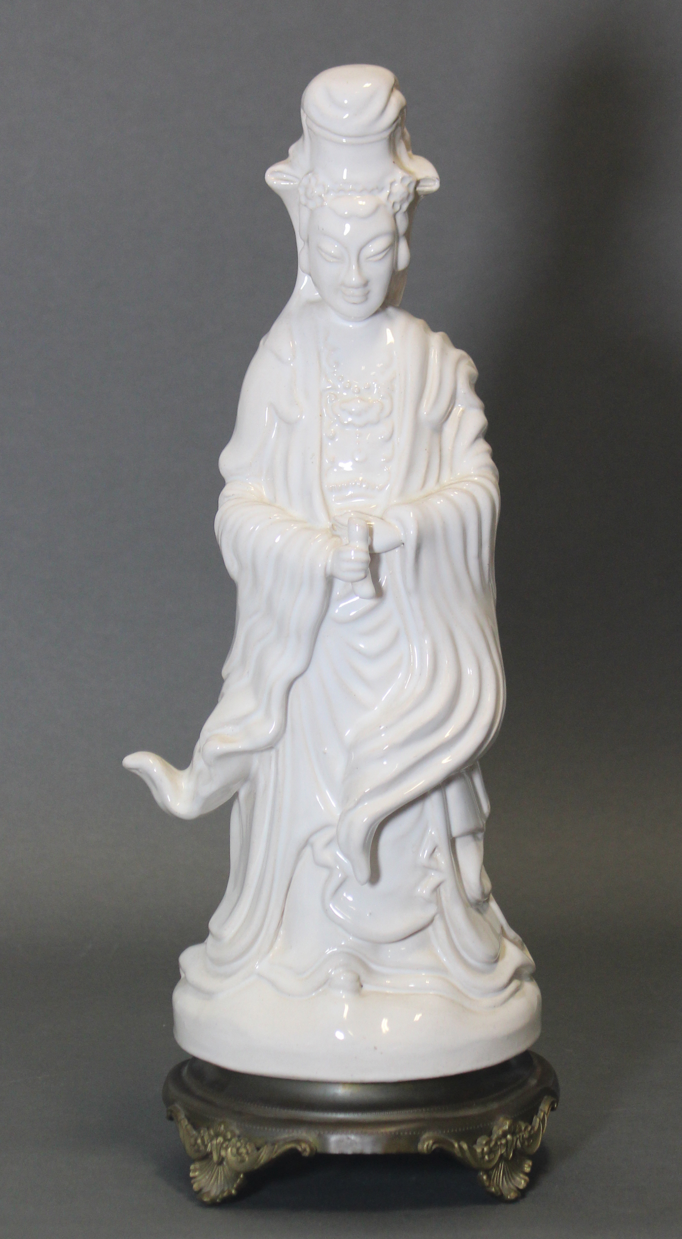 A modern white tin-glazed earthenware standing figure of Guanyin, 14¾” high, on later cast metal