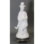 A modern white tin-glazed earthenware standing figure of Guanyin, 14¾” high, on later cast metal