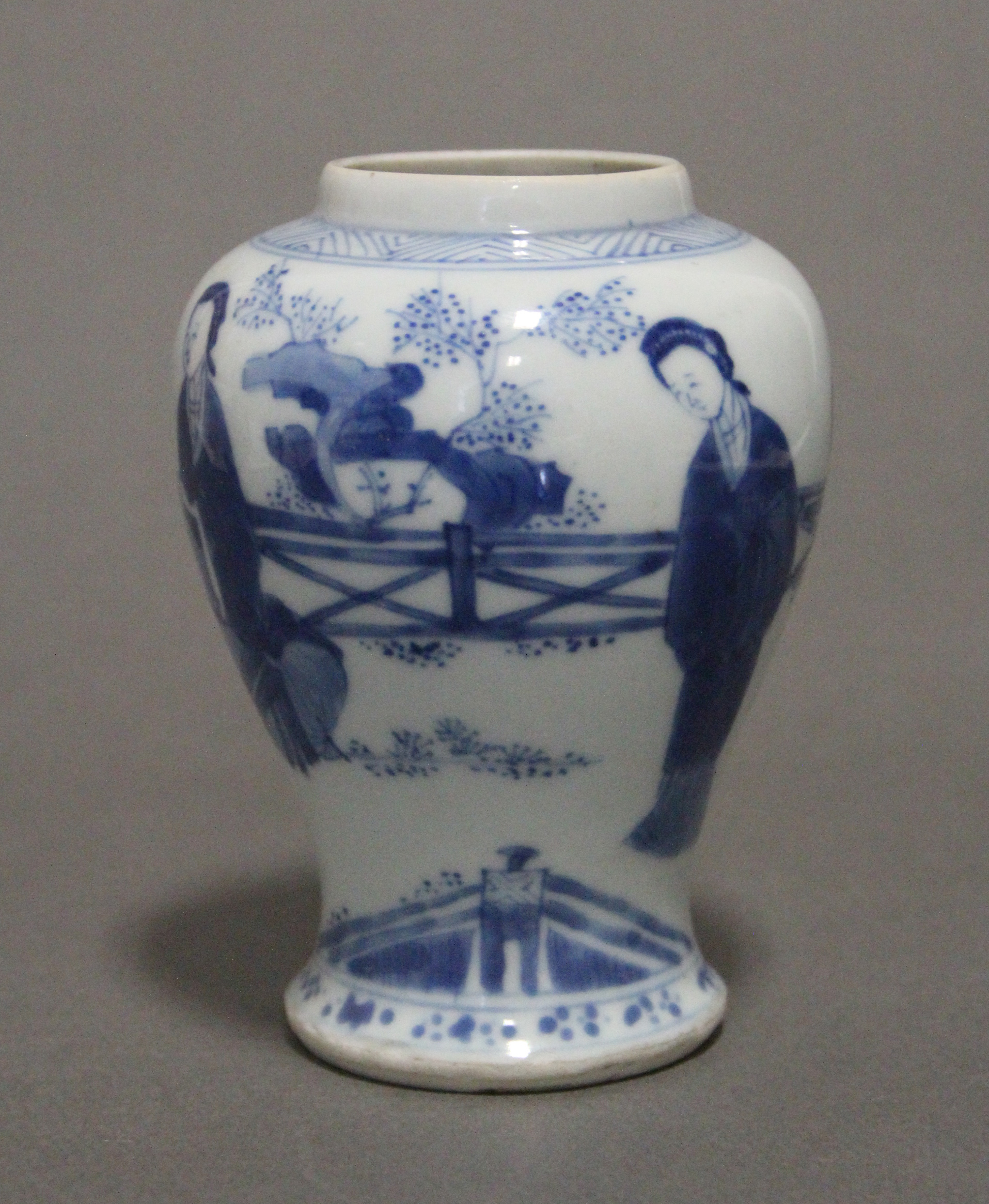 A Chinese Kangxi period blue & white porcelain small baluster vase painted with ladies in a formal