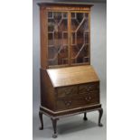 An Irish George III style mahogany bureau bookcase, the top section enclosed by a pair of astragal