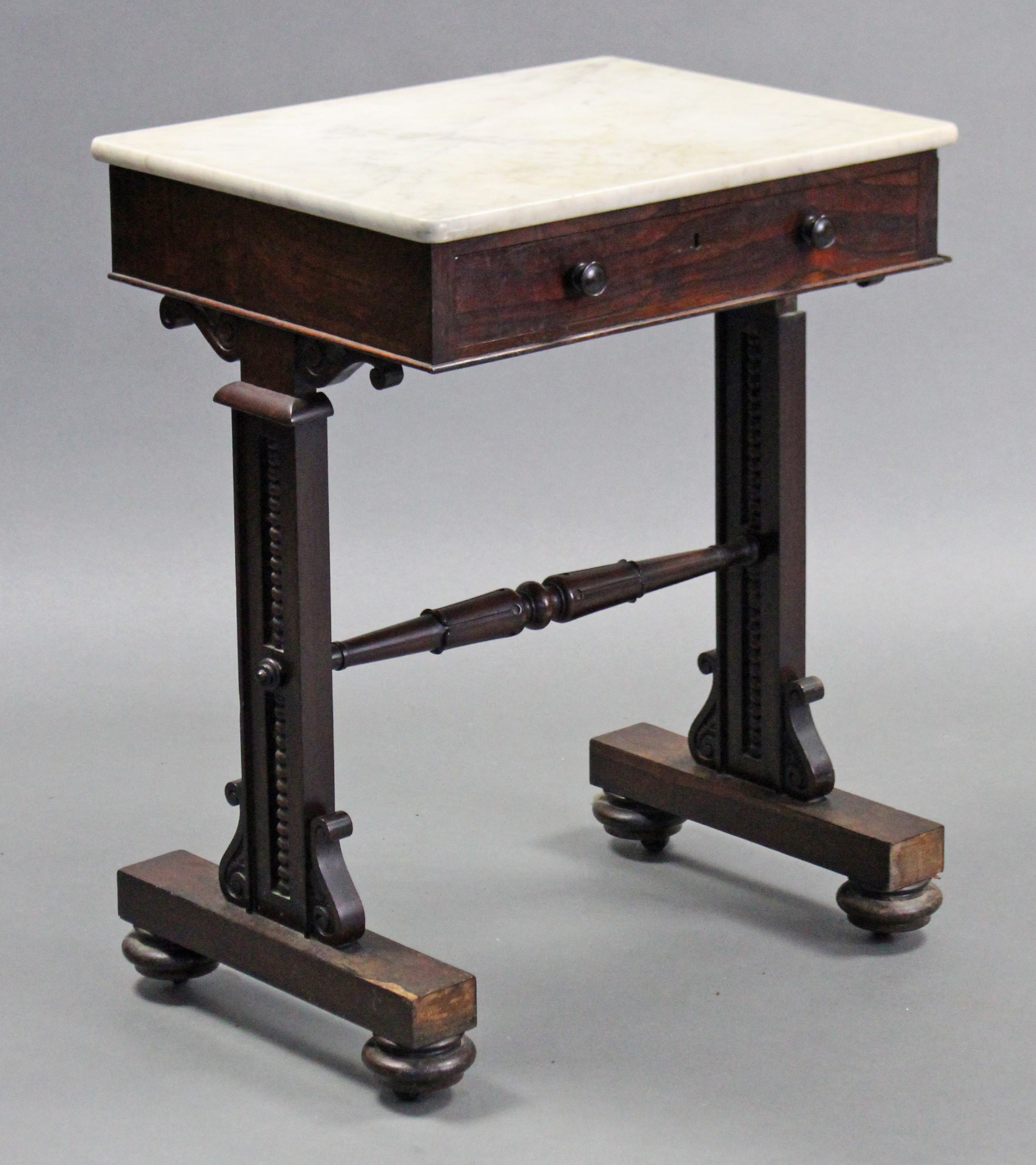 A regency rosewood side table, with rectangular marble top, fitted frieze drawer with turned knob