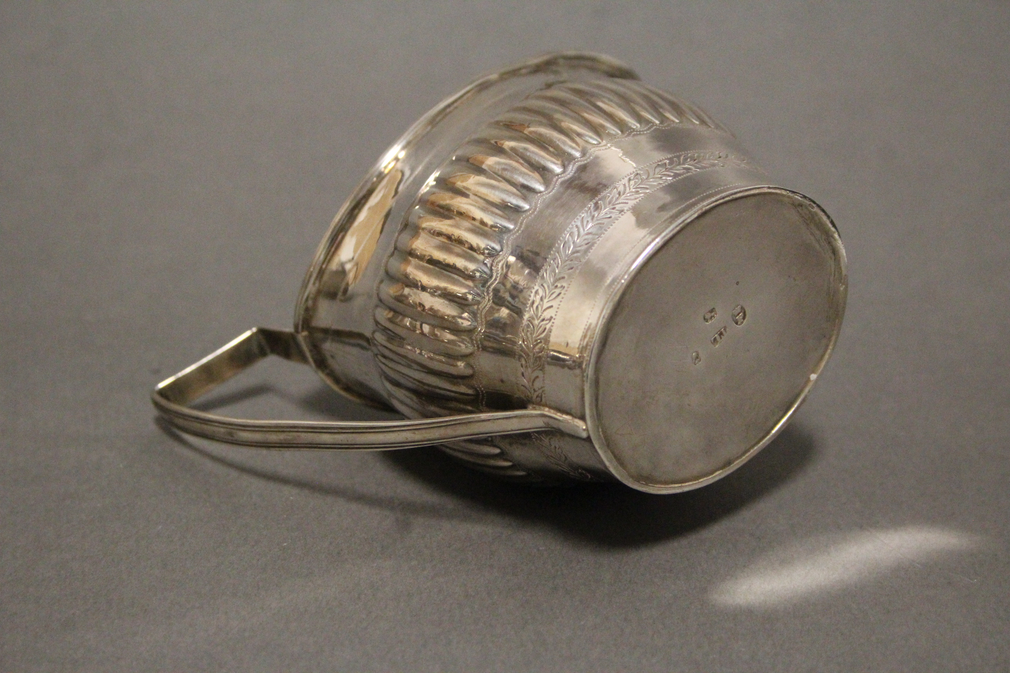 A George III silver oval semi-fluted cream jug with engraved foliate band, reeded angular - Image 2 of 2