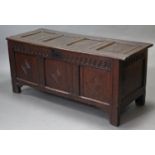 A 17th century joined oak coffer with panelled front, back & sides, hinged lift-lid & on short stump