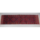 A Meshwari runner of deep blue, crimson, & ivory ground, with row of five lozenges in multiple