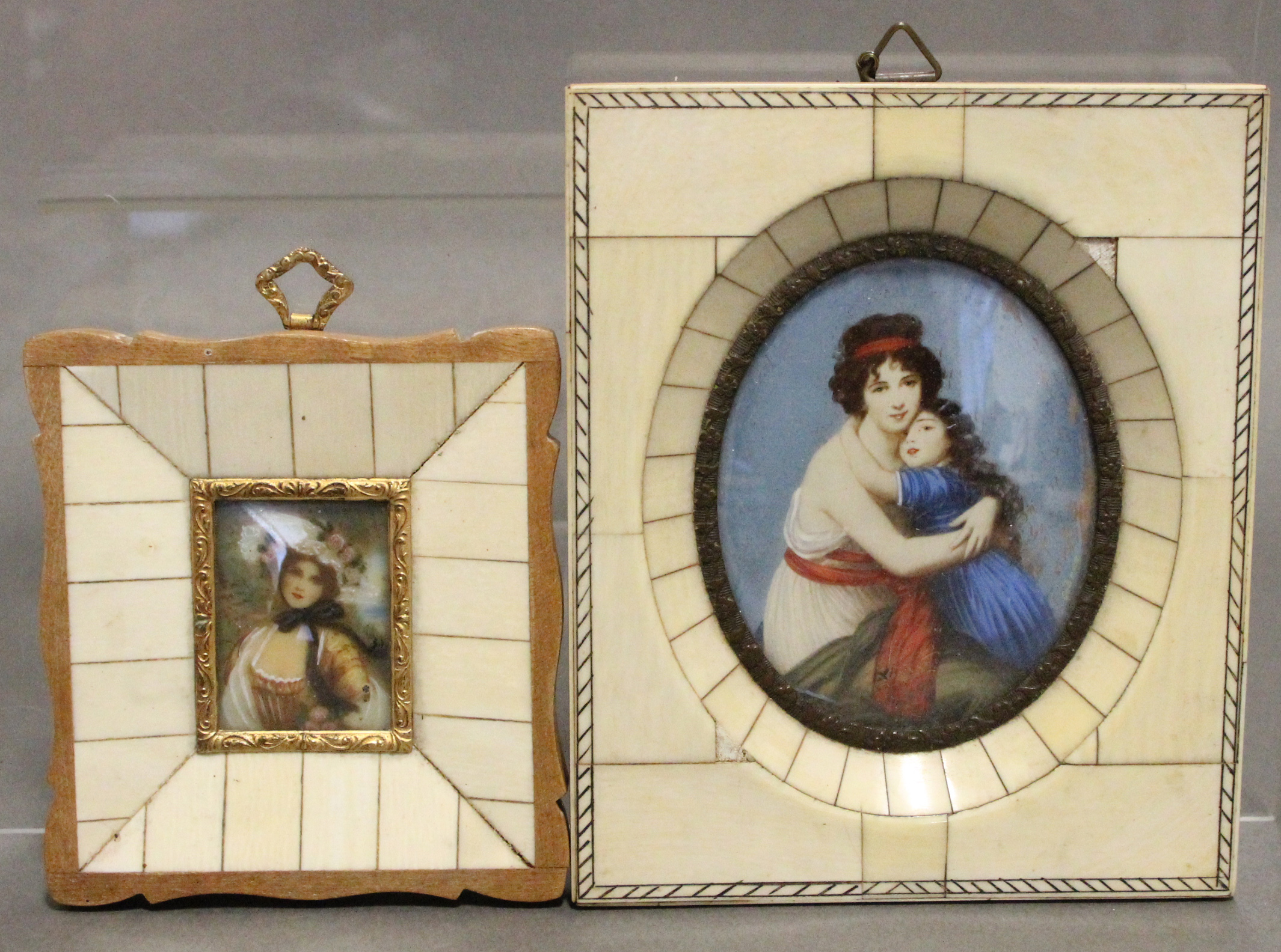 A decorative oval miniature painting of a mother & child, signed: “Le Brun”, 3¼” x 2½”, in ivory-