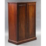 A mid-19th century mahogany office cabinet, fitted twenty-one adjustable shelves enclosed by a