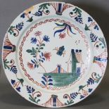 AN 18th century ENGLISH POLYCHROME DELFT LARGE DISH, decorated in blue, red, & green with a