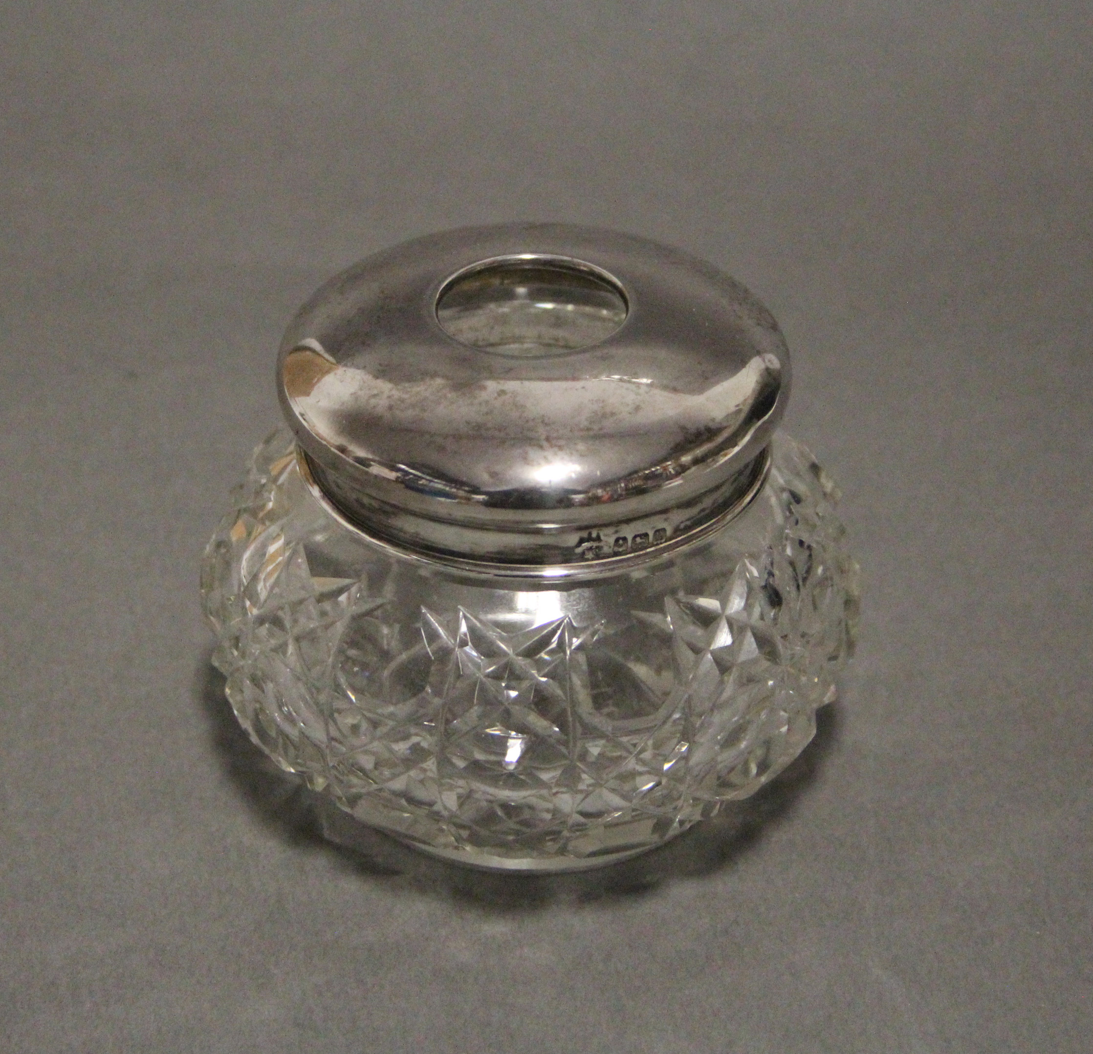 An early 20th century cut glass round dressing table jar with silver cover, 3½” x 3”; Birmingham