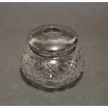 An early 20th century cut glass round dressing table jar with silver cover, 3½” x 3”; Birmingham