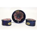 A Moorcroft “Anemone” small trefoil-shaped box & cover, 2¾” wide; an oval ditto, 3”; & a ditto