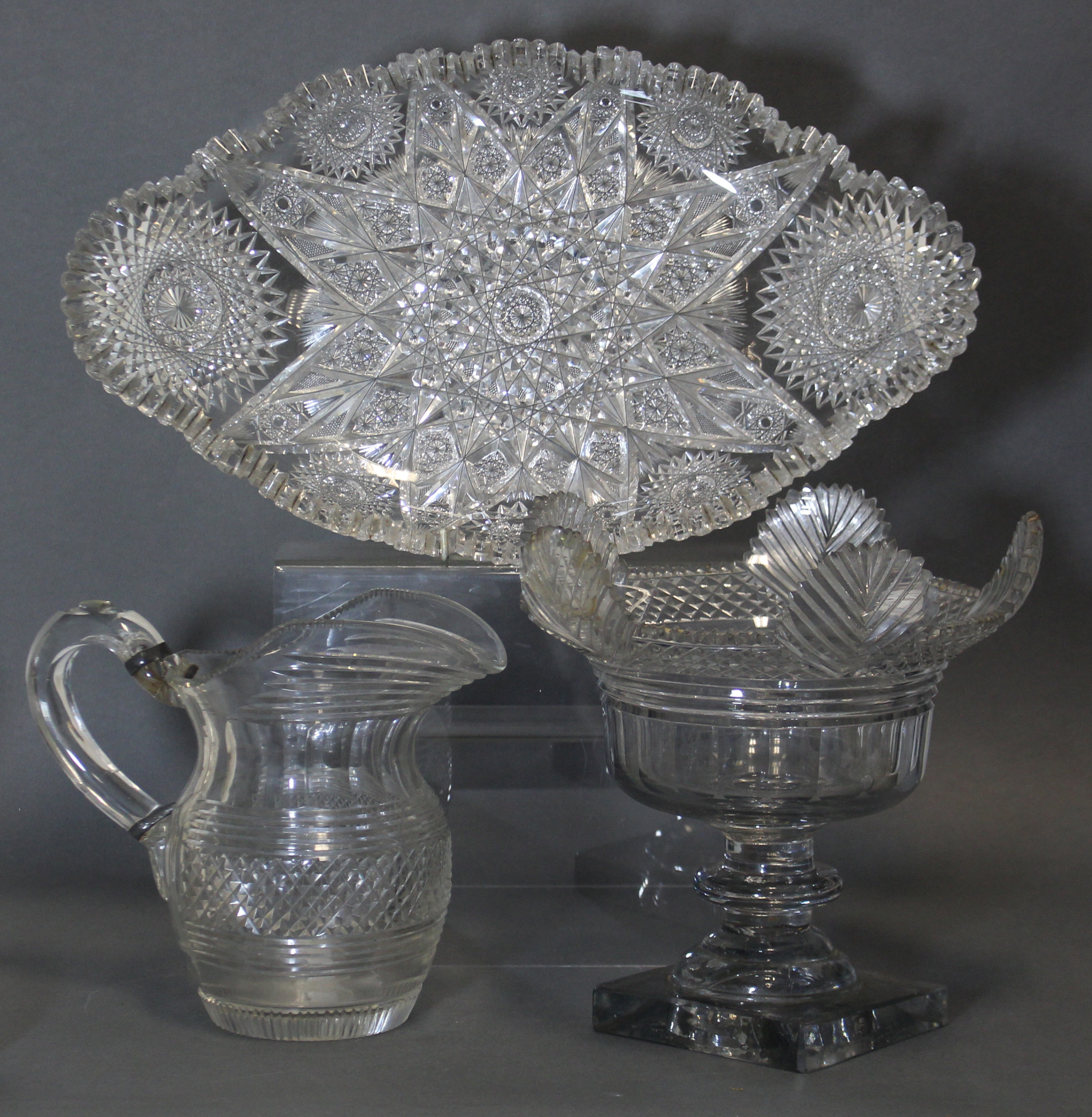 An early 19th century cut-glass deep bowl with lobed rim & fluted body, on turned column & heavy