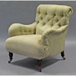 A Victorian armchair with long padded seat, buttoned scroll back, & padded arms upholstered pale