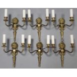 A set of six 20th century cast brass twin-branch wall lights of foliate design; each 9” wide x 13”