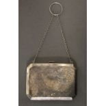 A George V engraved silver rectangular evening purse with canted corners, tan leather interior, &