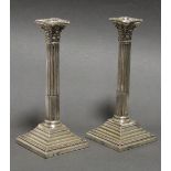 A pair of late Victorian silver large candlesticks, the round stop-fluted columns with composite