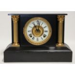 An Ansonia mantel clock in cast-iron architectural black & gilt case, the 4½” white enamel dial with
