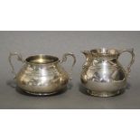 A George V heavy-gauge silver milk jug in the early 18th century style, of squat baluster form