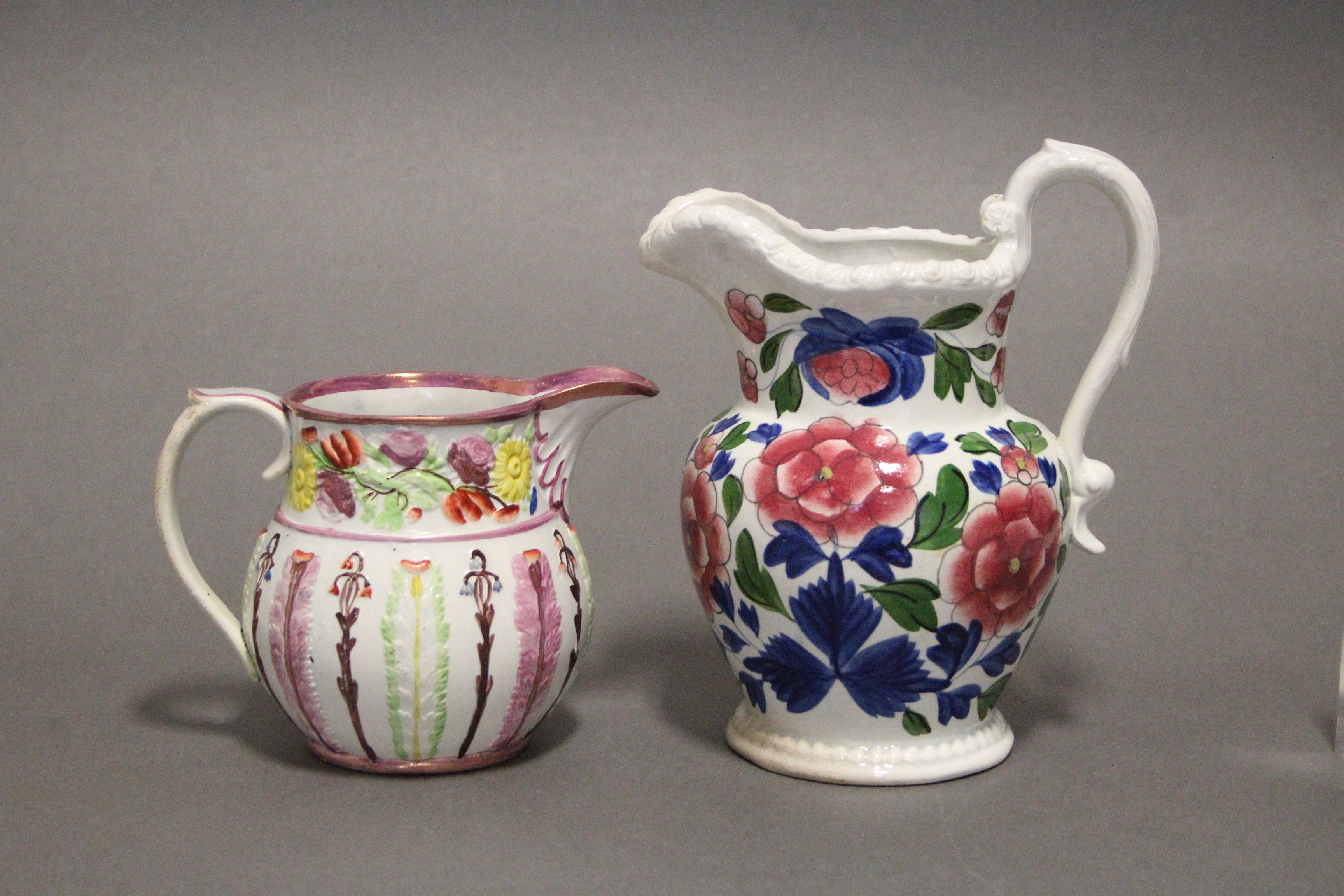 An early 19th century Swansea pottery bulbous jug with gadrooned rim, & with floral decoration in