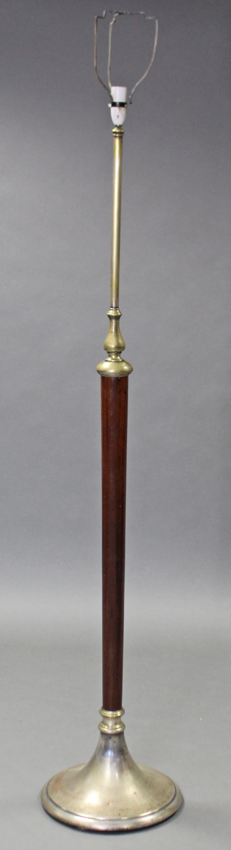 An early 20th century mahogany & brass standard lamp on tapering centre column & silvered circular