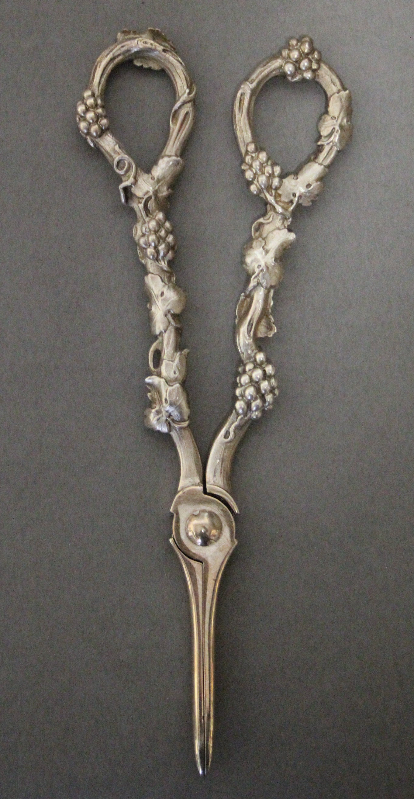 A pair of modern silver grape scissors with cast grapevine handles; London 1978.