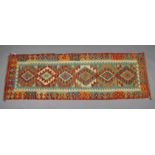 A Choli Kelim runner of multi-coloured ground with row of six lozenges in geometric borders; 6’8”