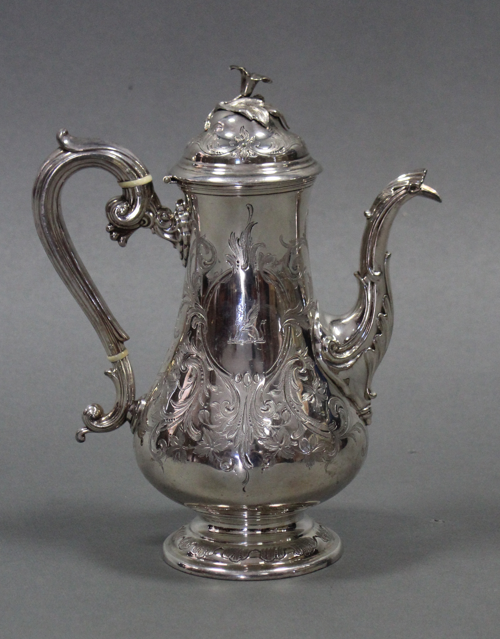 A Victorian baluster-shaped coffee pot with domed hinged lid, engraved leaf-scroll decoration, &