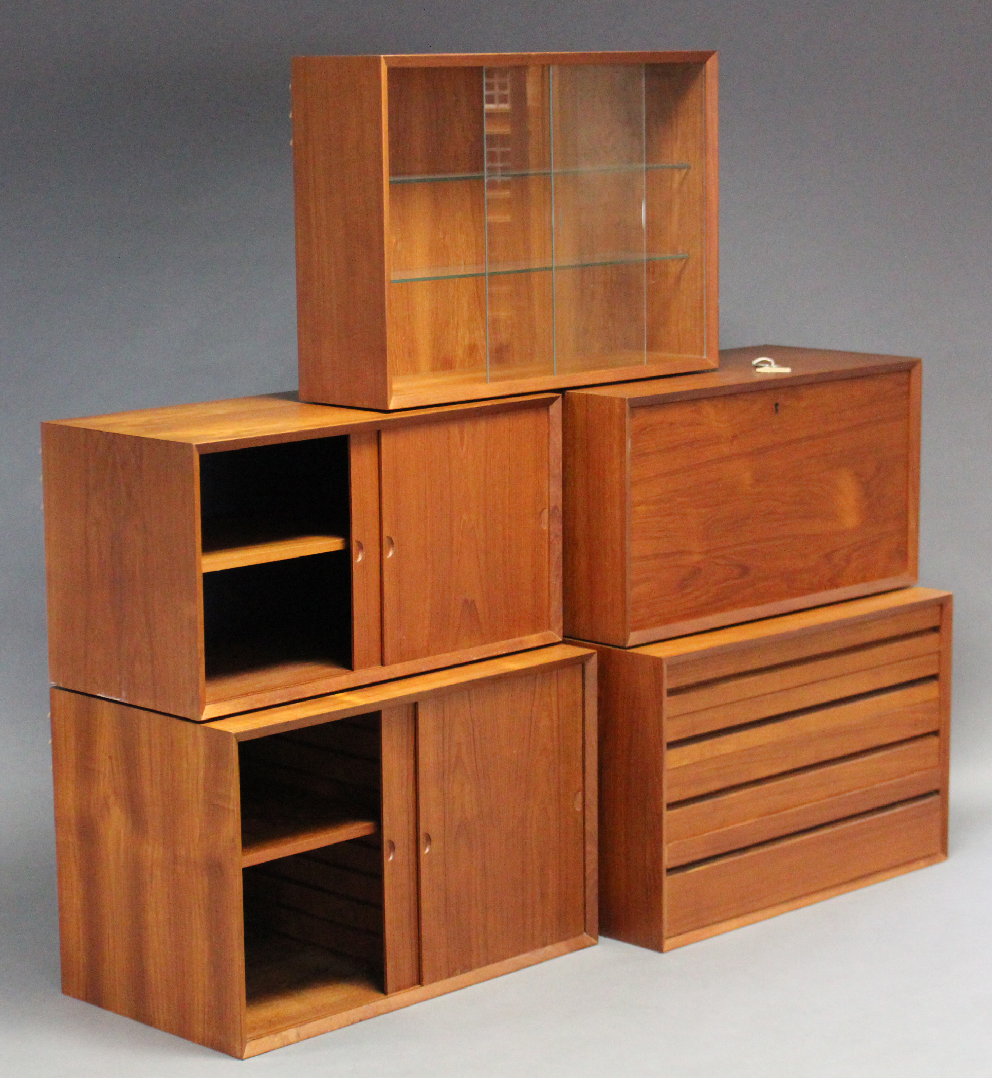 A 1960’s DANISH TEAK MODULAR INTER-CHANGEABLE WALL UNIT DESIGNED BY POUL CADOVIUS, fitted with an