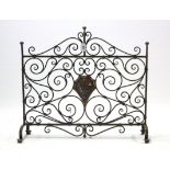 A wrought-iron fire-screen, 28½” wide; a cast-iron shoe rack; a similar saucepan stand; & a