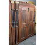 A continental-style grained pine wardrobe enclosed by pair of panel doors, with half turned
