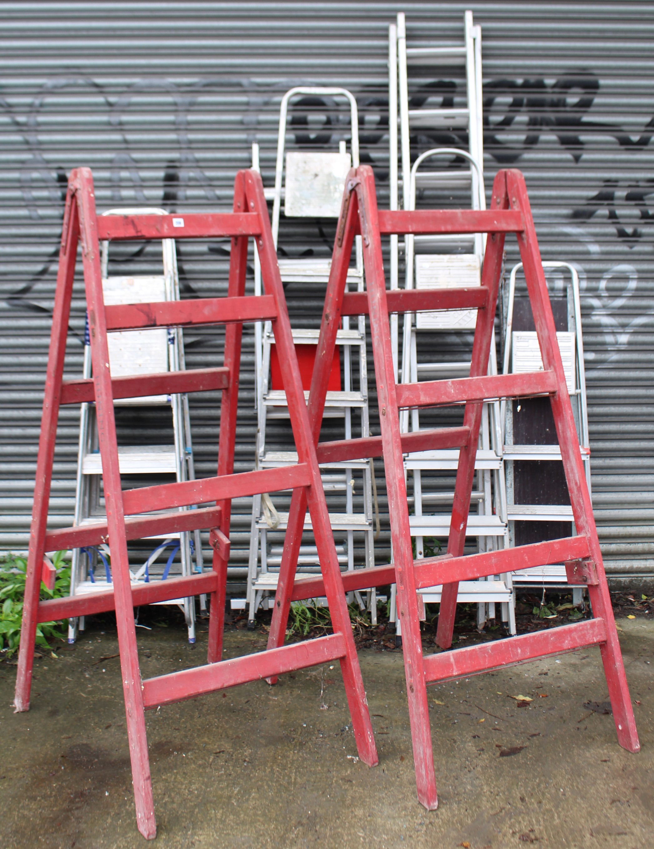 A pair of crimson painted wooden tall decorator’s trestles, 72” high; & seven various aluminium step - Image 2 of 9