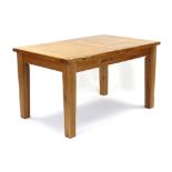 A modern light oak extending dining table with pull-out action, two removable leaves, & on square