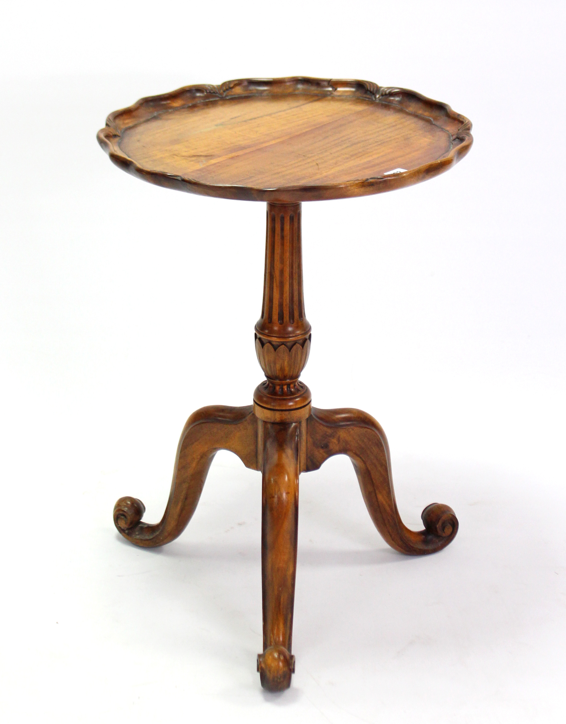 A hardwood tripod table with moulded pie-crust edge to the circular top, & on fluted & vase-turned