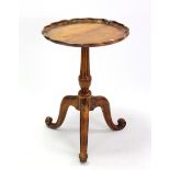 A hardwood tripod table with moulded pie-crust edge to the circular top, & on fluted & vase-turned
