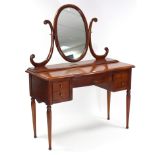 A reproduction mahogany break-front knee-hole dressing table with oval swing mirror to the stage