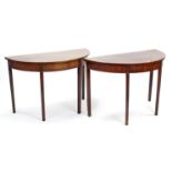 A pair of 19th century inlaid-mahogany demi-lune dining table end sections, each on four square