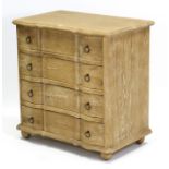 A limed oak small break-front chest fitted four long drawers with brass ring handles, & on ball