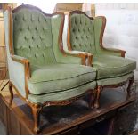 A pair of continental-style carved beech frame buttoned-back armchairs upholstered pale green