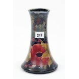 A Moorcroft “Pomegranate” pattern trumpet-shaped vase, signed W. Moorcroft to base, 8½” high.