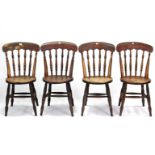 A set of four late Victorian spindle-back kitchen chairs with circular hard seats, & on turned