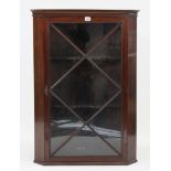 A 19th century hanging corner cabinet, fitted two shaped shelves enclosed by glazed door, 27” wide x