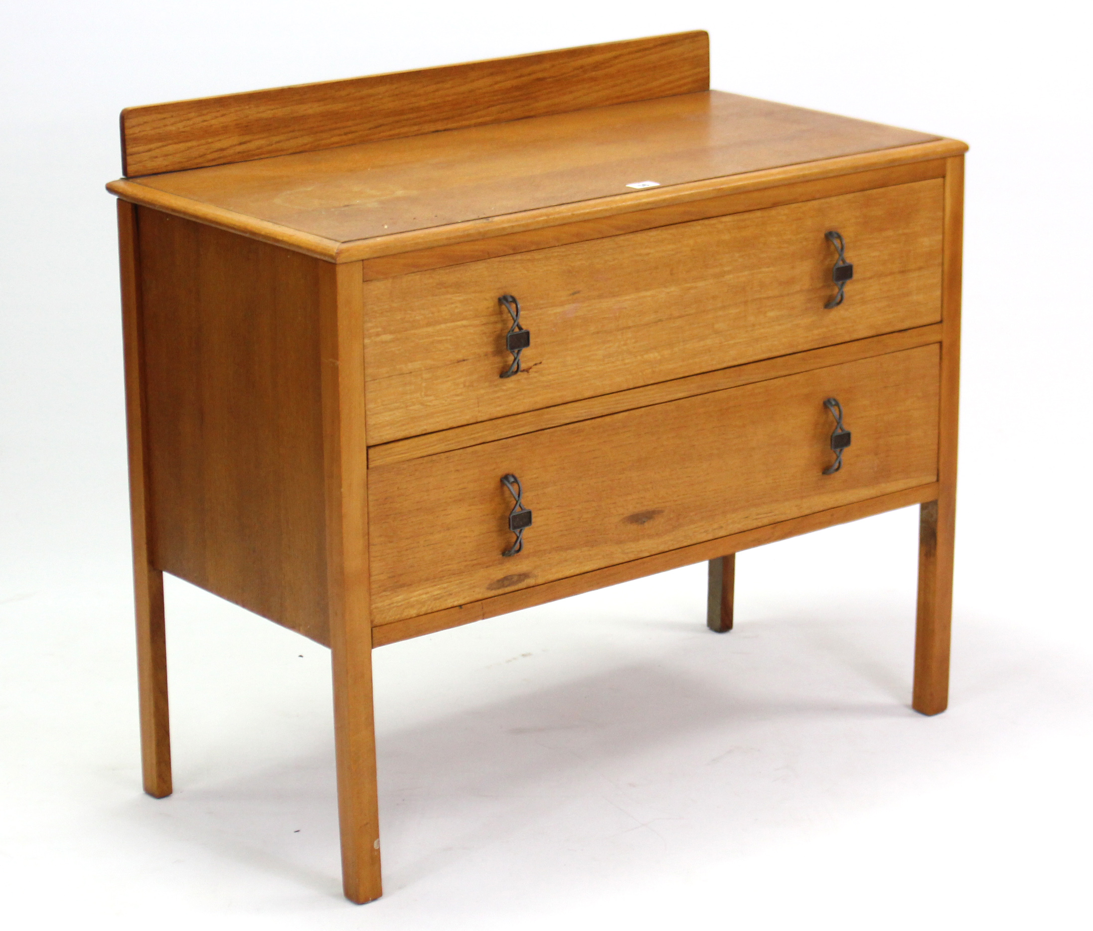 A light oak dwarf chest fitted two long drawers, & on short square legs, 34½” wide.