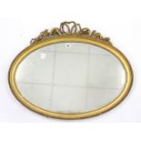 A 19th century gilt gesso frame oval wall mirror inset bevelled plate, 26” x 33” (w.a.f.).