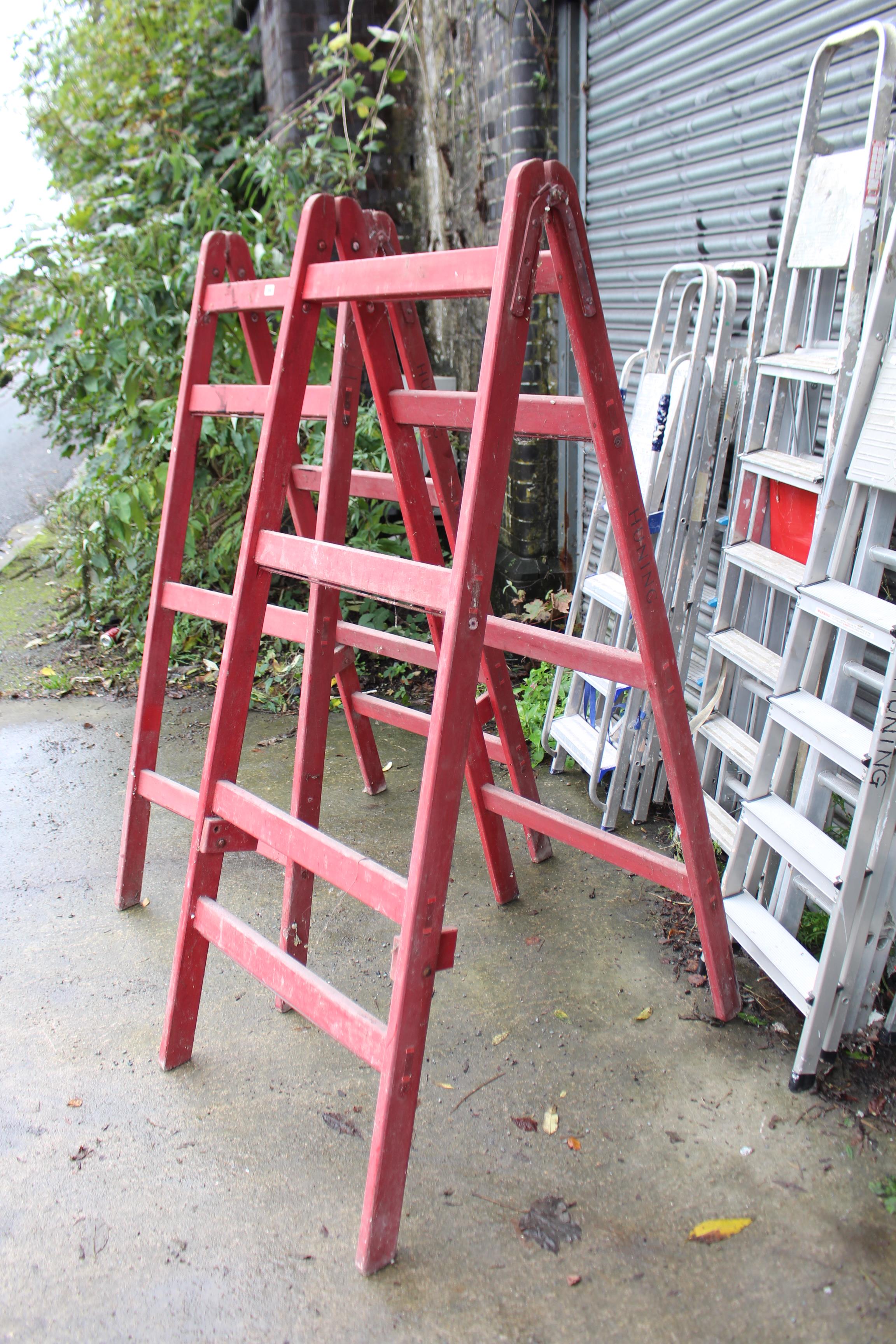 A pair of crimson painted wooden tall decorator’s trestles, 72” high; & seven various aluminium step - Image 5 of 9