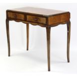 A mid-20th century burr-walnut side table with carved border, fitted two frieze drawers, & on