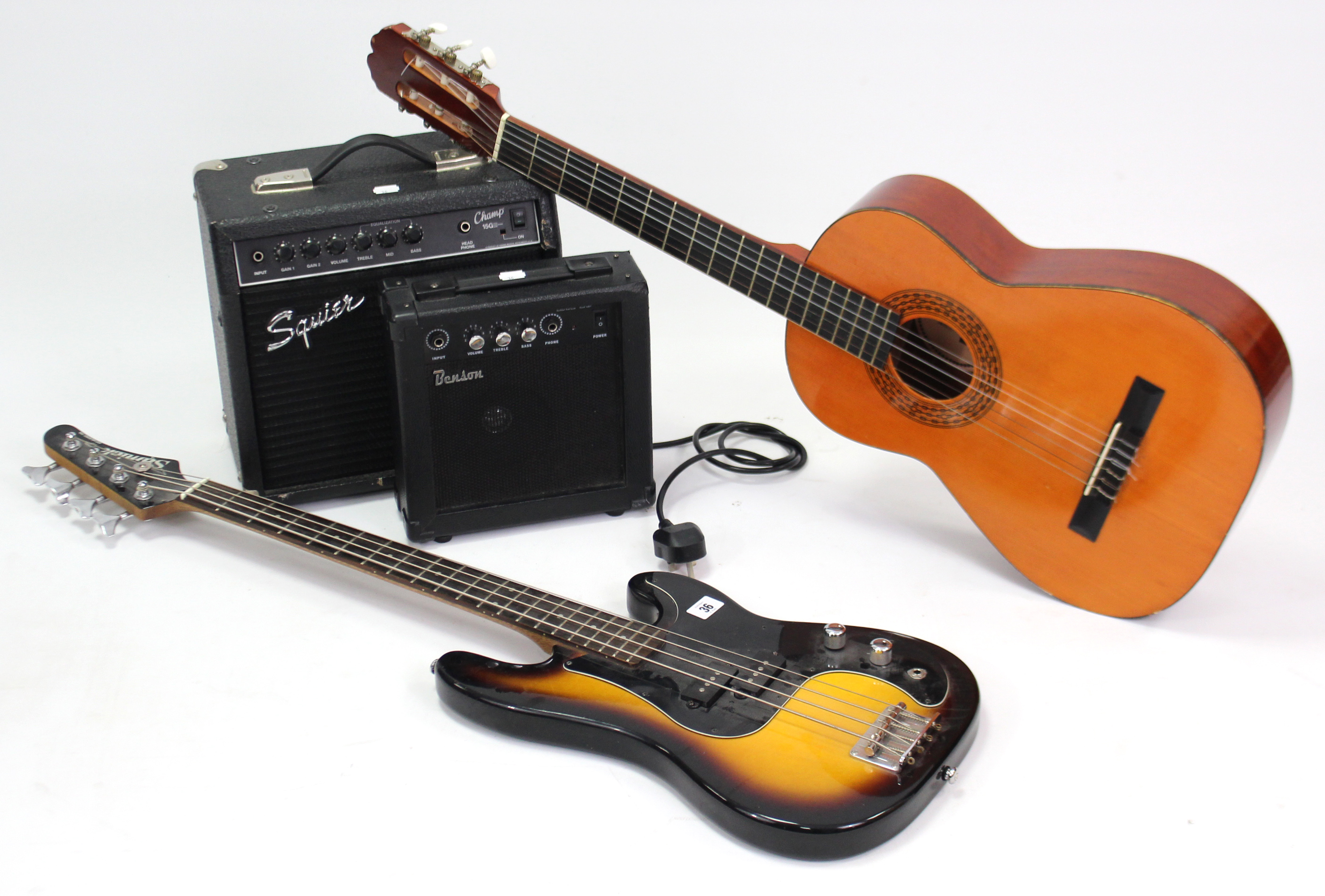 A Samick four-string electric guitar; a Squier “Champ 15G” practice amplifier; a Benson bass