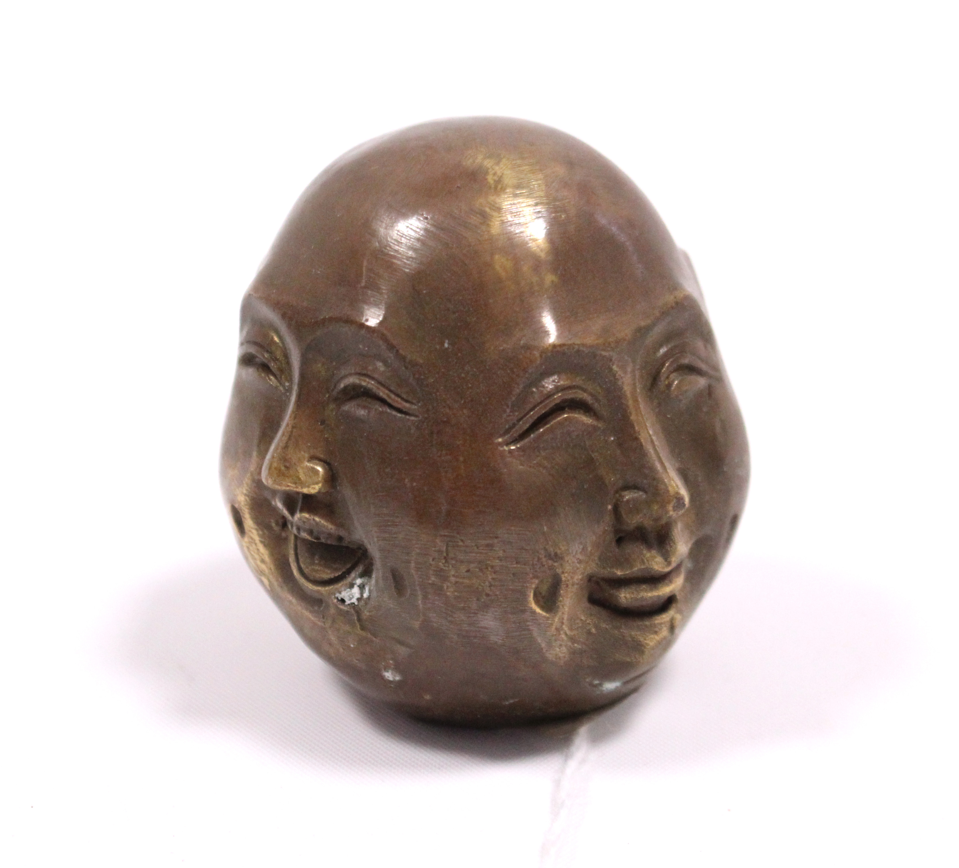 A modern bronzed four-faced Buddha head ornament, 2¼” high.