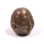 A modern bronzed four-faced Buddha head ornament, 2¼” high.